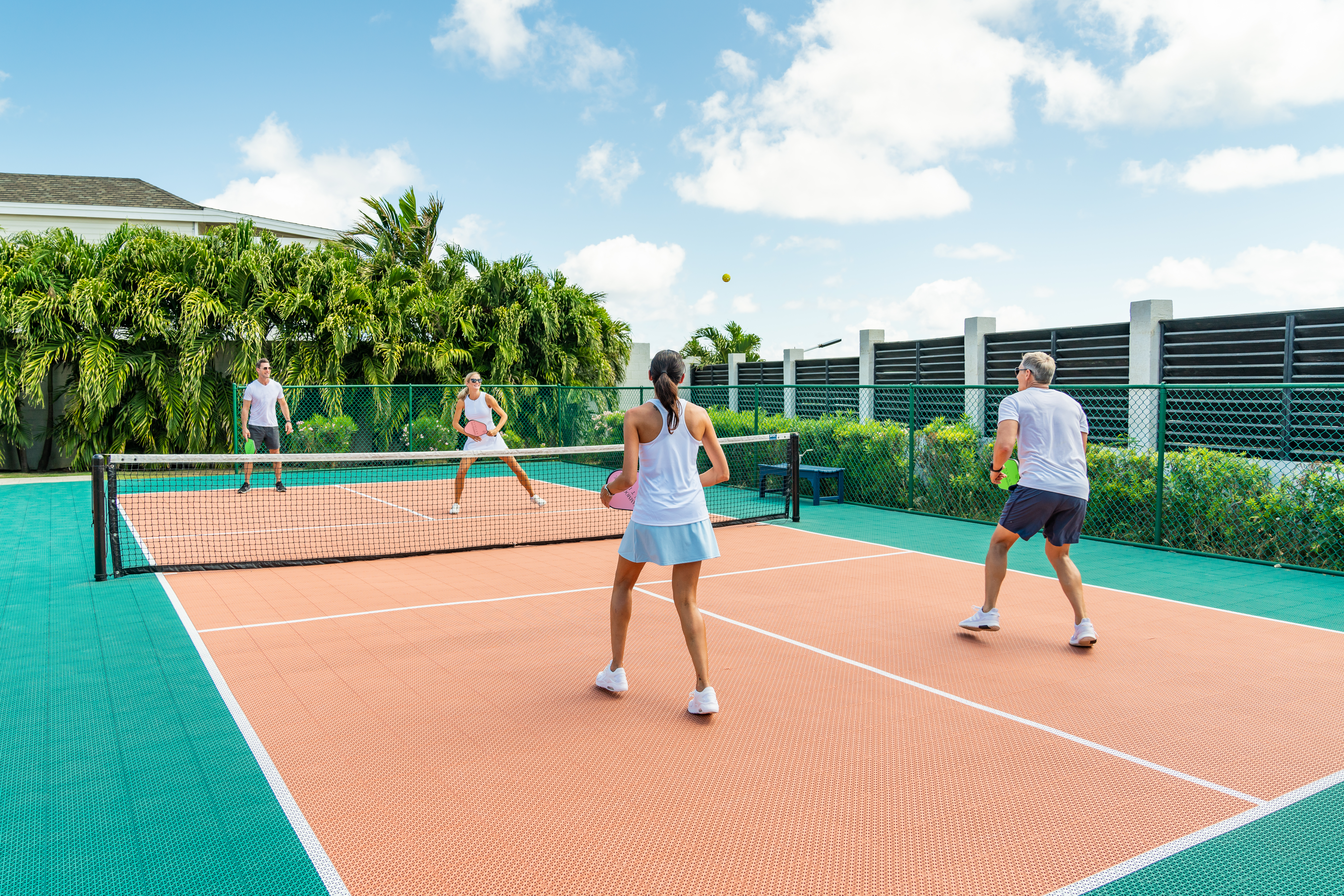 Guests playing pickleball with ocean view
